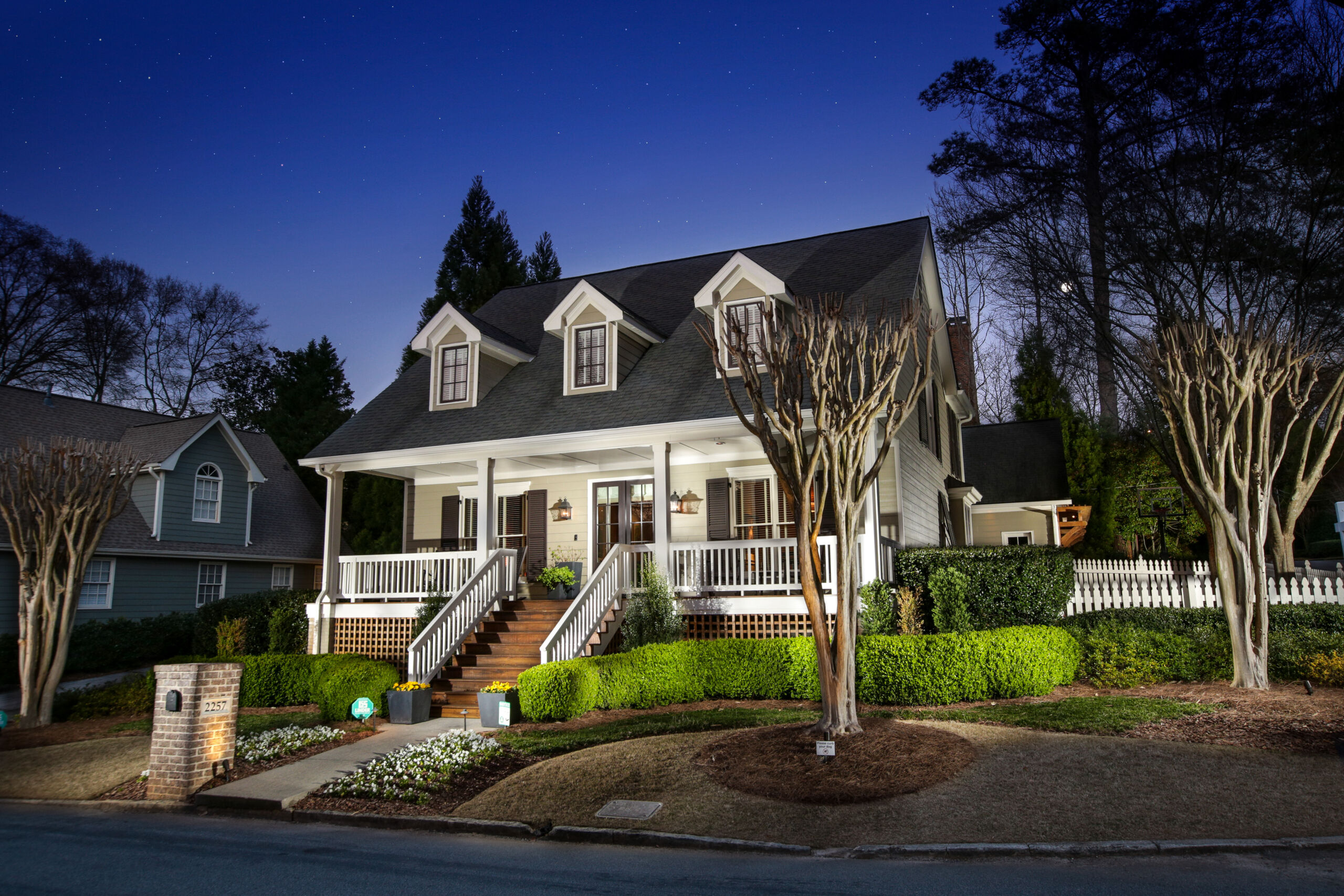 A residence photographed at dusk with interior lights on